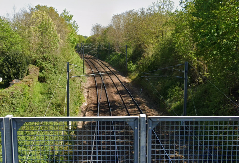 La végétation est abondante aux abords des voies sur la ligne Paris - Caen - Cherbourg. Ici au Vieil-Evreux, dans l'Eure -